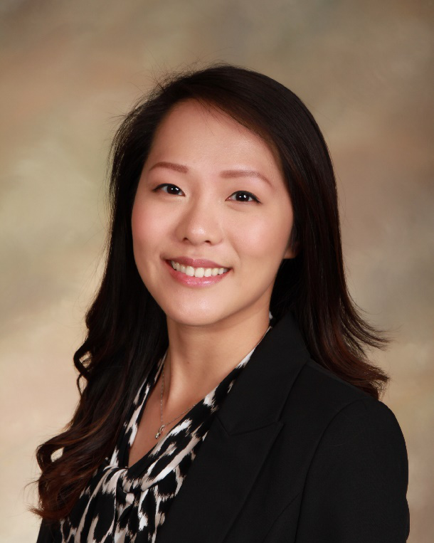 A woman with long hair wearing a black jacket.